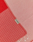 Alcazar Turkish towel in Red Charm – Close-up draped towel showing detail and texture