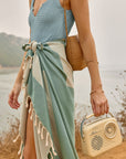 Comb Turkish towel in Sage – tied around waist while walking with retro radio and straw bag