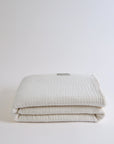 Summer Blanket in Naturel – Neatly folded blanket with smooth edges, showcasing softness