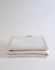 Summer Blanket in Naturel – Folded gauze blanket with corner flipped to show inner layer