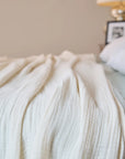 Summer Blanket in Naturel – Blanket spread on bed for lifestyle view