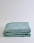Summer Blanket in Sage – Neatly folded blanket with clean finish and soft cotton texture