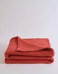 Summer Blanket in Terra – Neatly folded blanket highlighting warm earthy tone