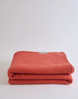 Summer Blanket in Terra – Folded blanket with open corner revealing inner gauze layers