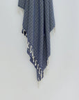 Alcazar Turkish towel in Indigo – Close-up hanging towel highlighting weave and softness