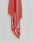Alcazar Turkish towel in Red Charm – Close-up hanging towel highlighting weave and softness