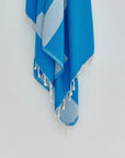 Comb Turkish towel in Marine – Close-up hanging towel highlighting weave and softness
