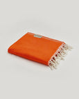Comb Turkish towel in Sicilian Orange – Neatly folded towel, compact and ready for use