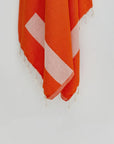 Comb Turkish towel in Sicilian Orange – Close-up hanging towel highlighting weave and softness