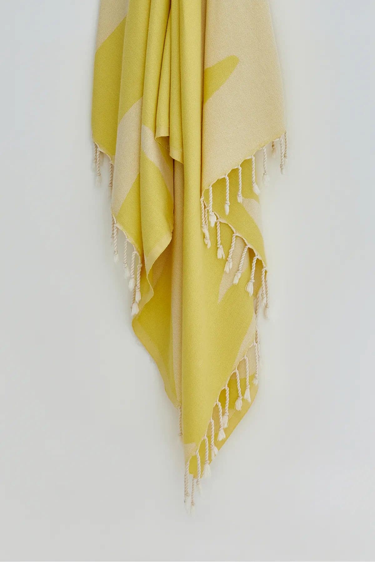 Fiori Turkish towel in Mellow Yellow – Close-up hanging towel highlighting weave and softness