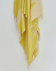 Fiori Turkish towel in Mellow Yellow – Close-up hanging towel highlighting weave and softness