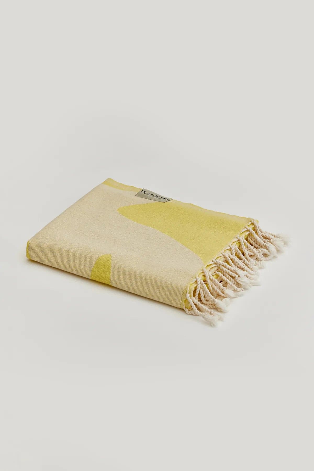 Fiori Turkish towel in Mellow Yellow – Neatly folded towel, compact and ready for use