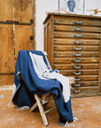 La Luna Turkish towel in Indigo – laid over folding chair at campsite for soft back support