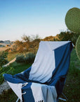 La Luna Turkish towel in Indigo – laid over folding chair at campsite for soft back support