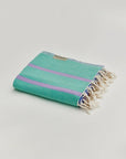 Lane Turkish towel in Lilac Green – Neatly folded towel, compact and ready for use