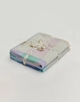 Pale Pluie Bundle – Folded bundle with multiple towels, tied with LILA N BERRY ribbon