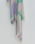 Pale Pluie Turkish towel in Mellow Green – Close-up hanging towel highlighting weave and softness