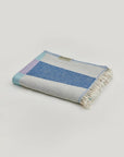 Pale Pluie Turkish towel in Mellow Indigo – Neatly folded towel, compact and ready for use