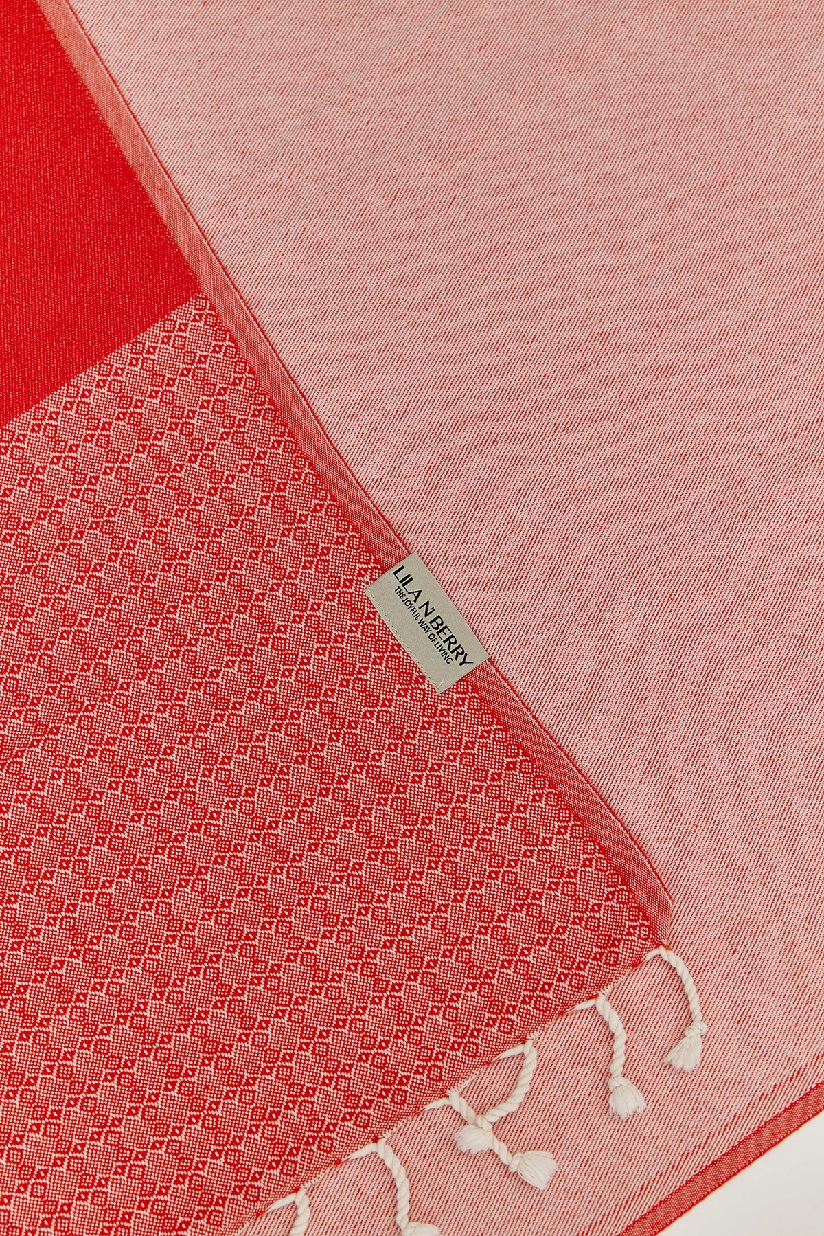 Alcazar Turkish towel in Red Charm – Close-up draped towel showing detail and texture