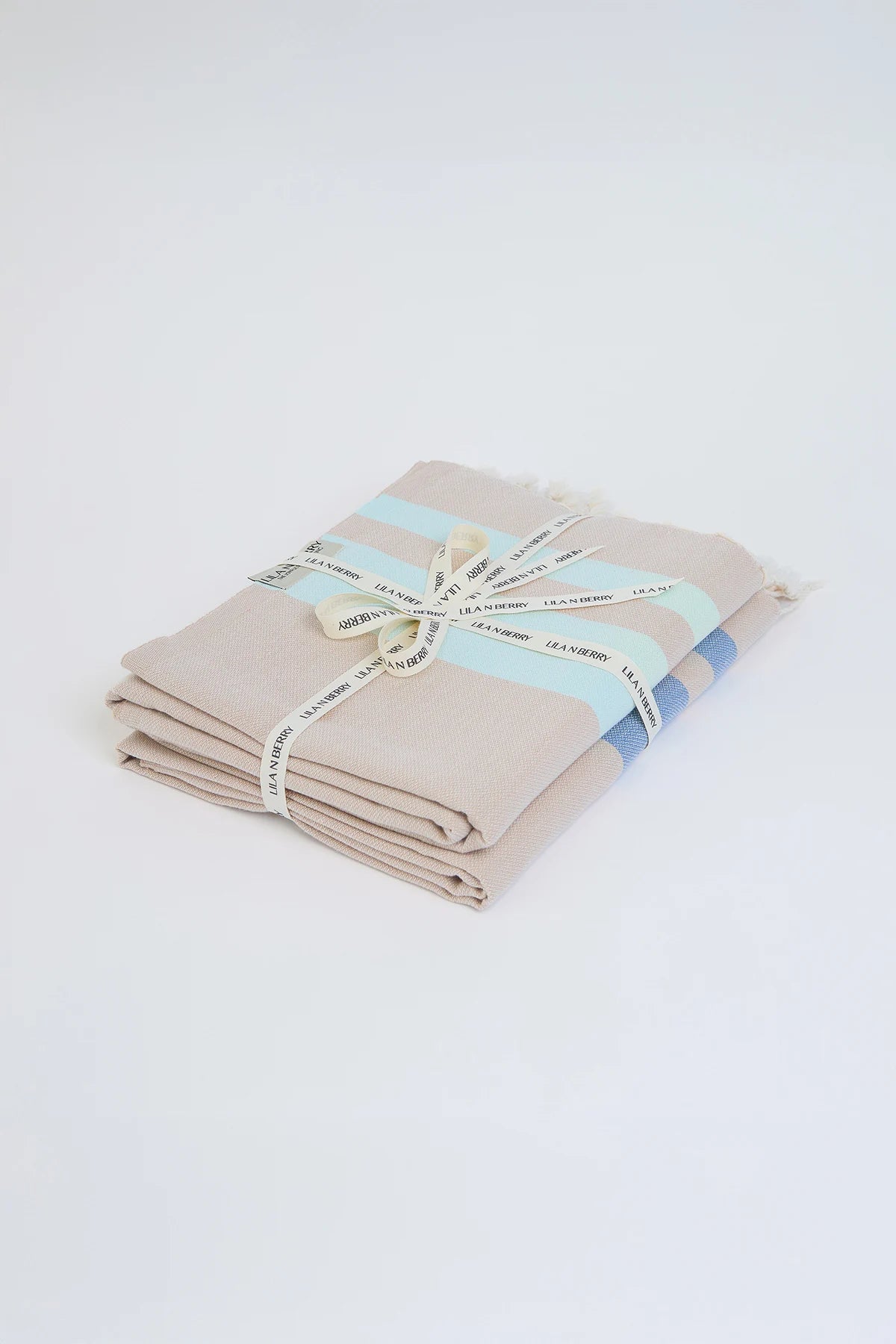 Bebe Coastal Bundle – Folded bundle with multiple towels, tied with LILA N BERRY ribbon