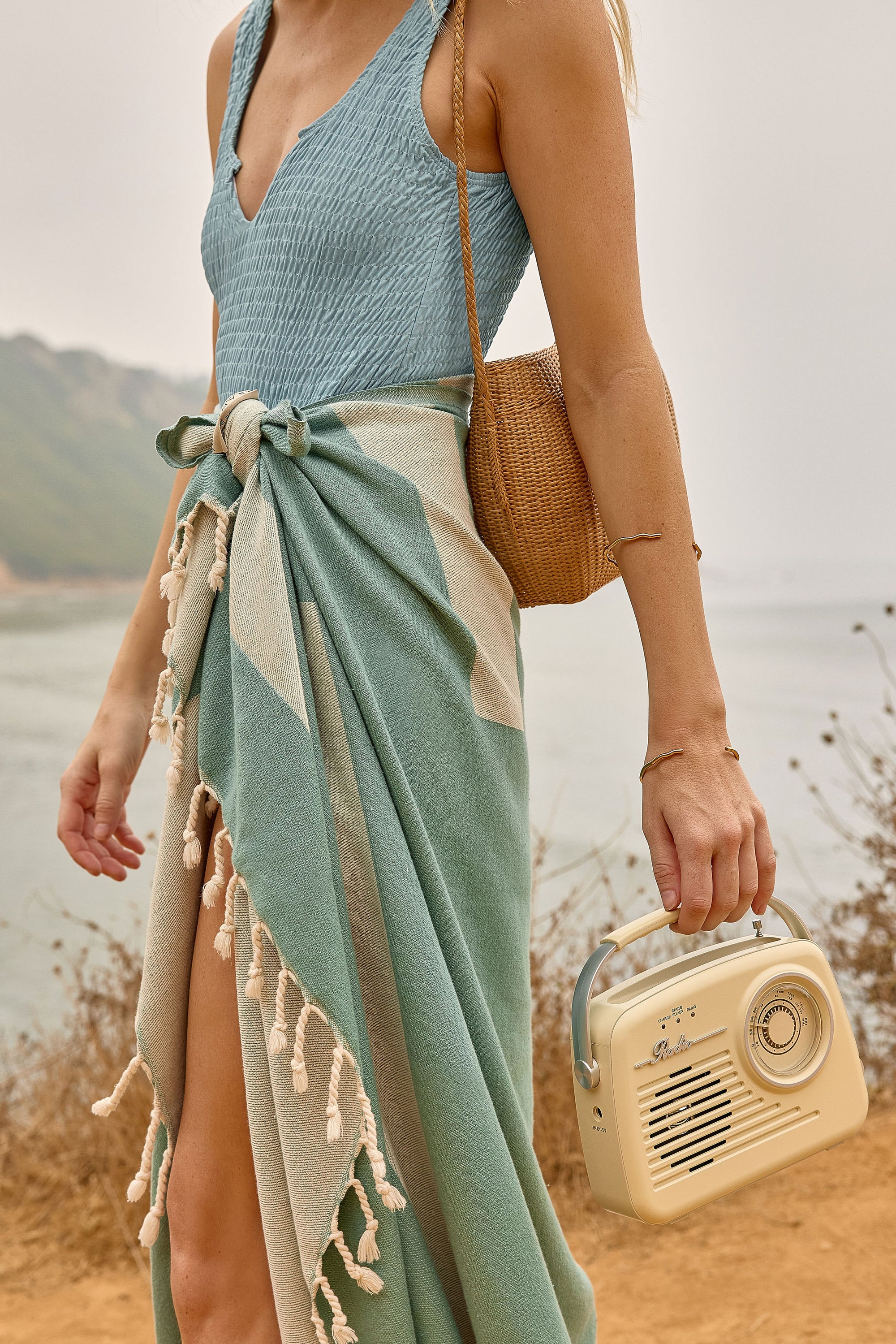 Comb Turkish towel in Sage – tied around waist while walking with retro radio and straw bag