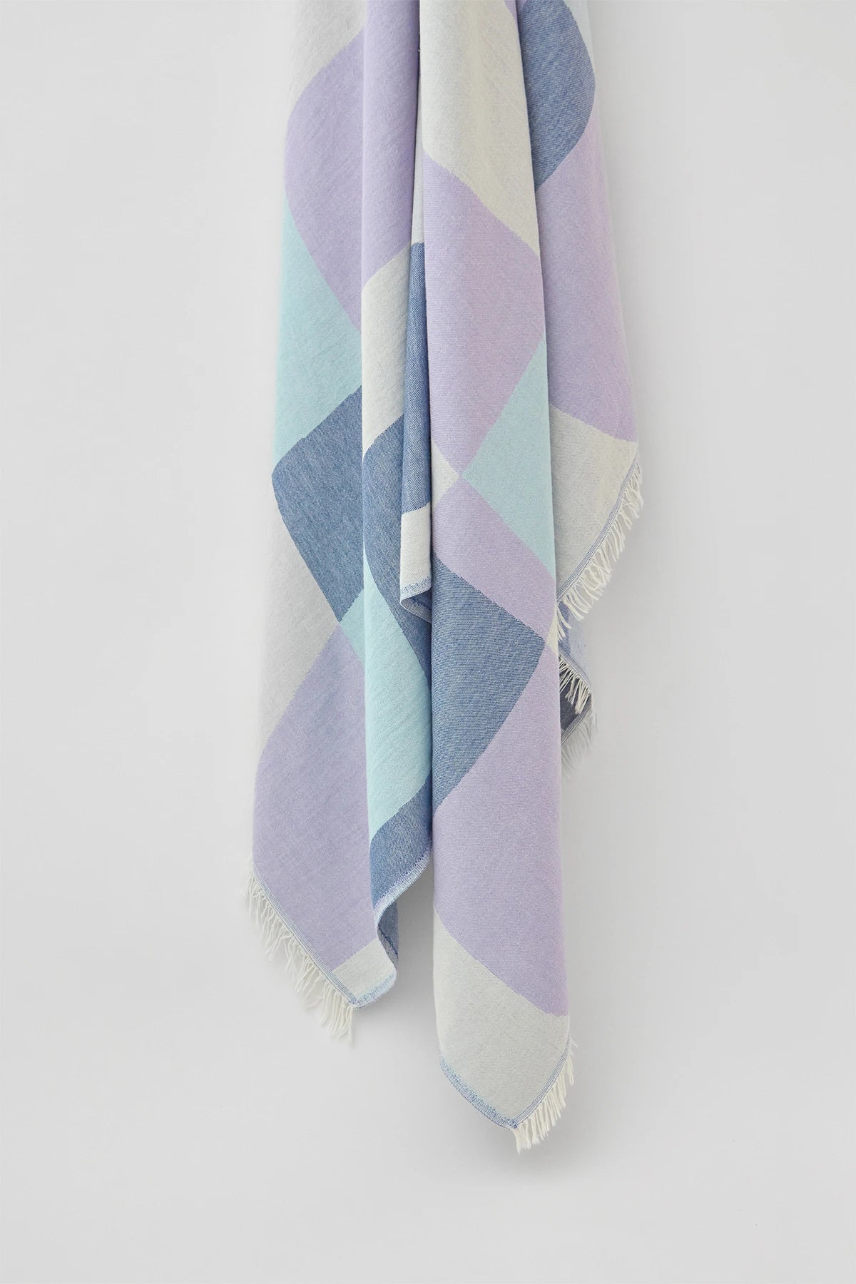 Pale Pluie Indigo X-Large Turkish towel in Mellow Indigo – Close-up hanging towel highlighting weave and softness