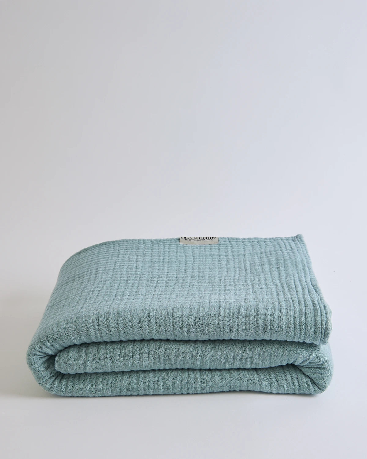 Summer Blanket in Sage – Neatly folded blanket with clean finish and soft cotton texture