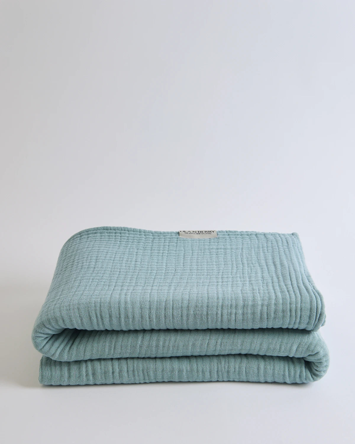 Summer Blanket in Sage – Layered cotton texture with open fold for cozy depth