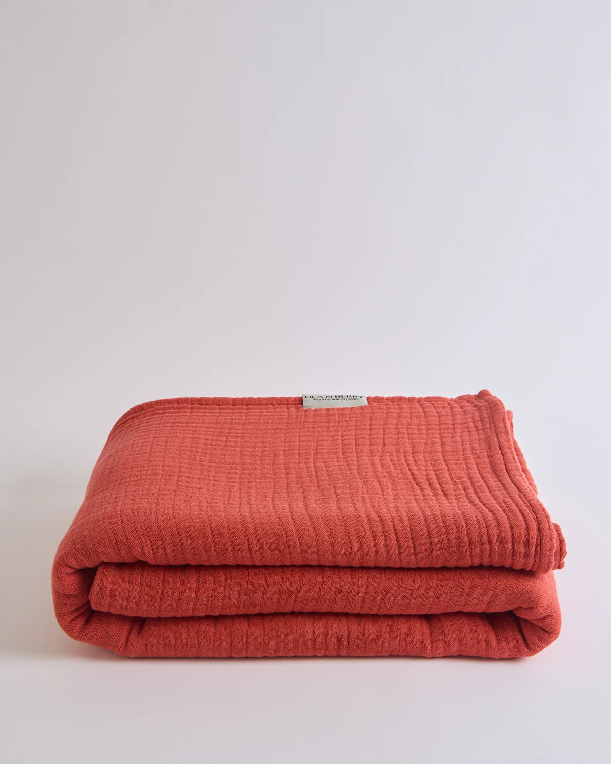 Summer Blanket in Terra – Folded terracotta-toned blanket with subtle gauze weave