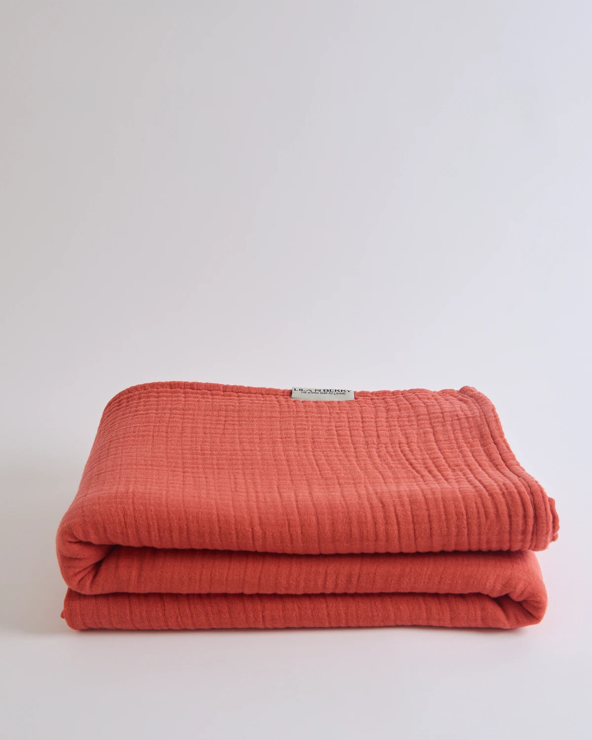 Summer Blanket in Terra – Folded blanket with open corner revealing inner gauze layers