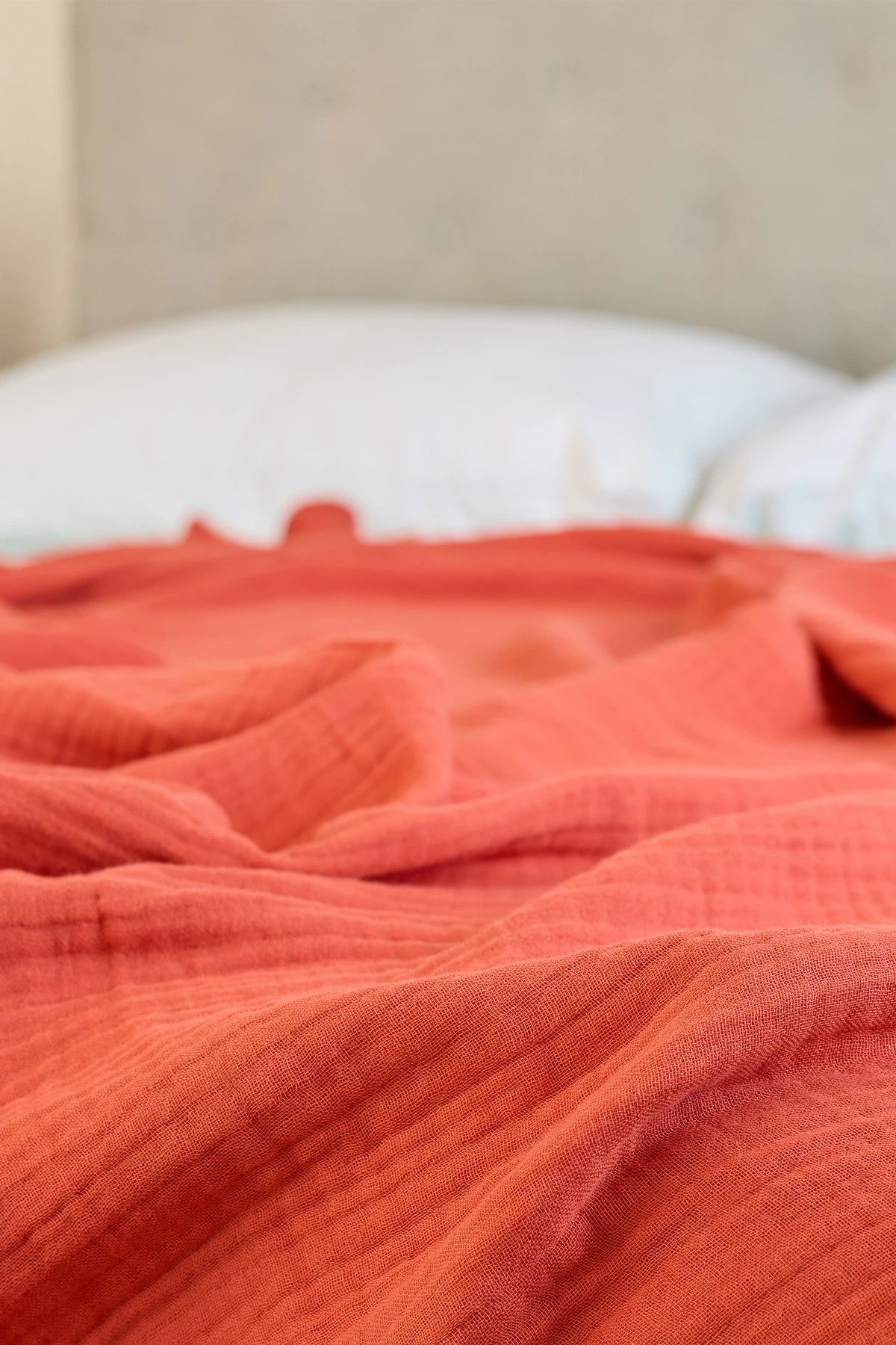 Summer Blanket in Terra – Blanket spread on bed for lifestyle view