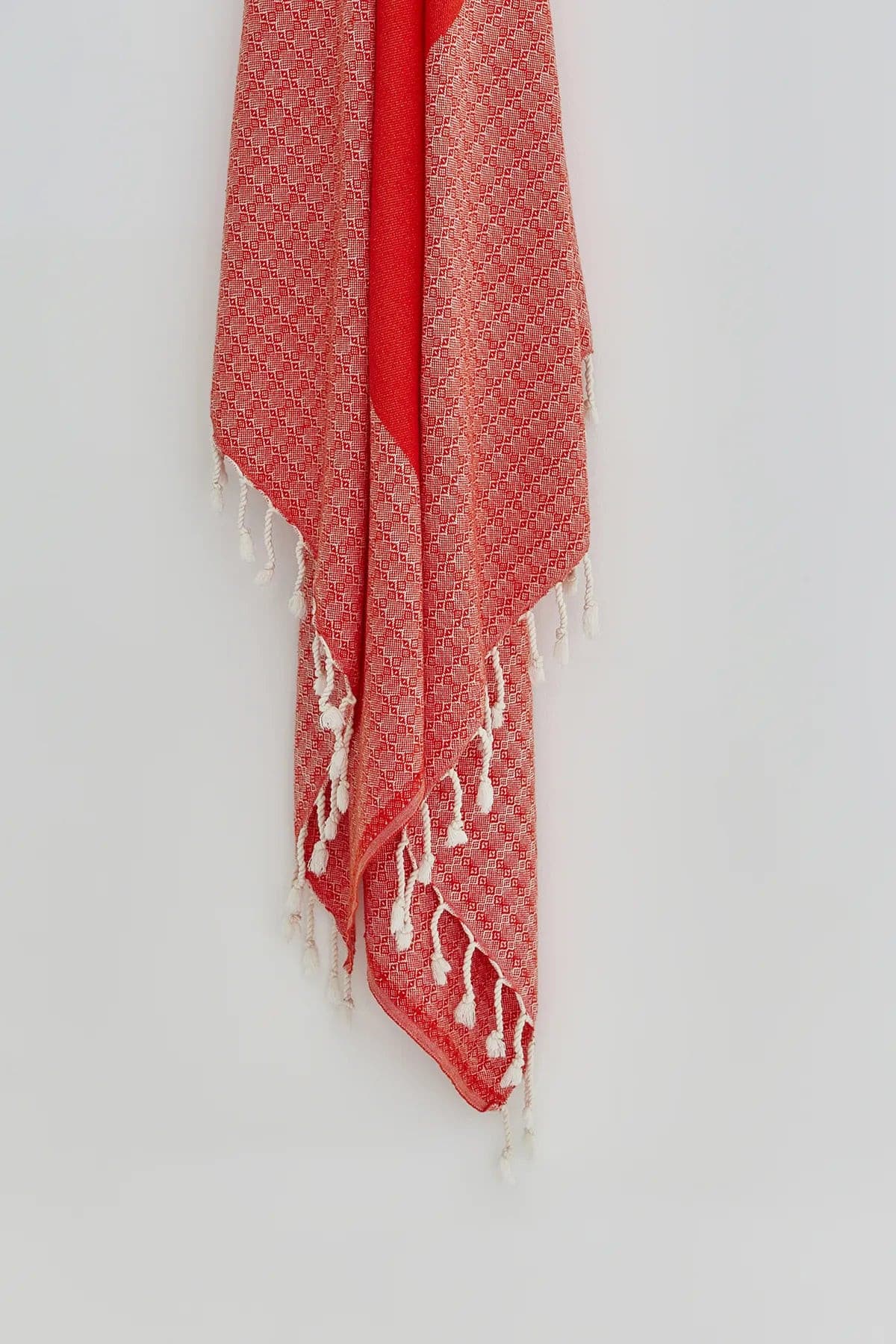 Alcazar Turkish towel in Red Charm – Close-up hanging towel highlighting weave and softness