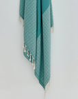 Alcazar Turkish towel in Sage – Close-up hanging towel highlighting weave and softness