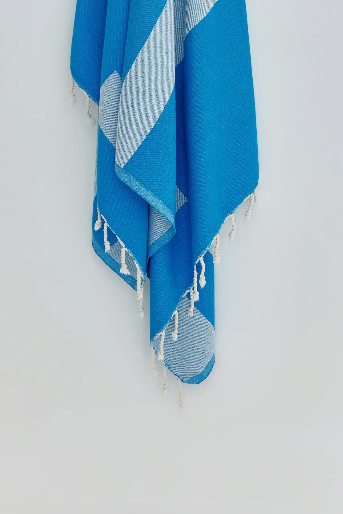 Comb Turkish towel in Marine – Close-up hanging towel highlighting weave and softness