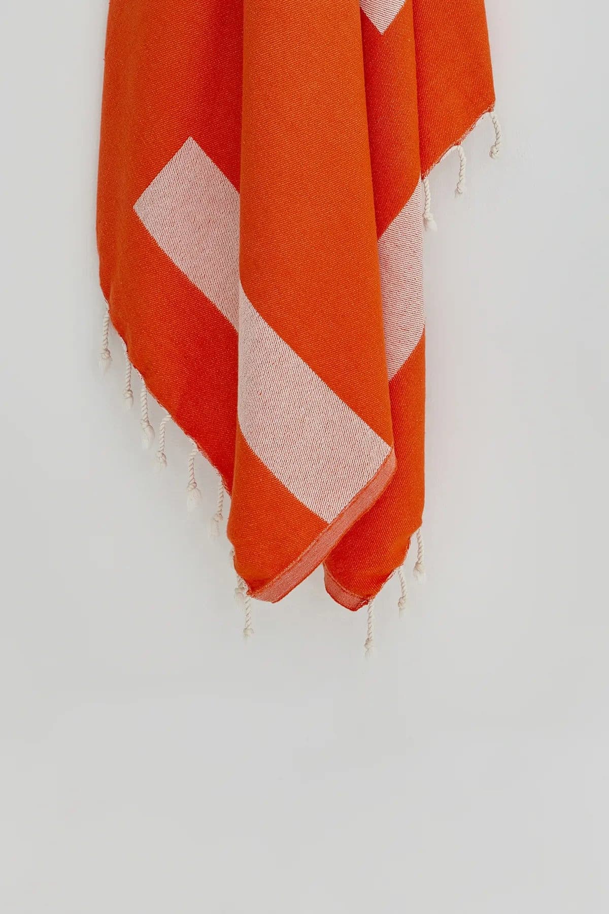 Comb Turkish towel in Sicilian Orange – Close-up hanging towel highlighting weave and softness