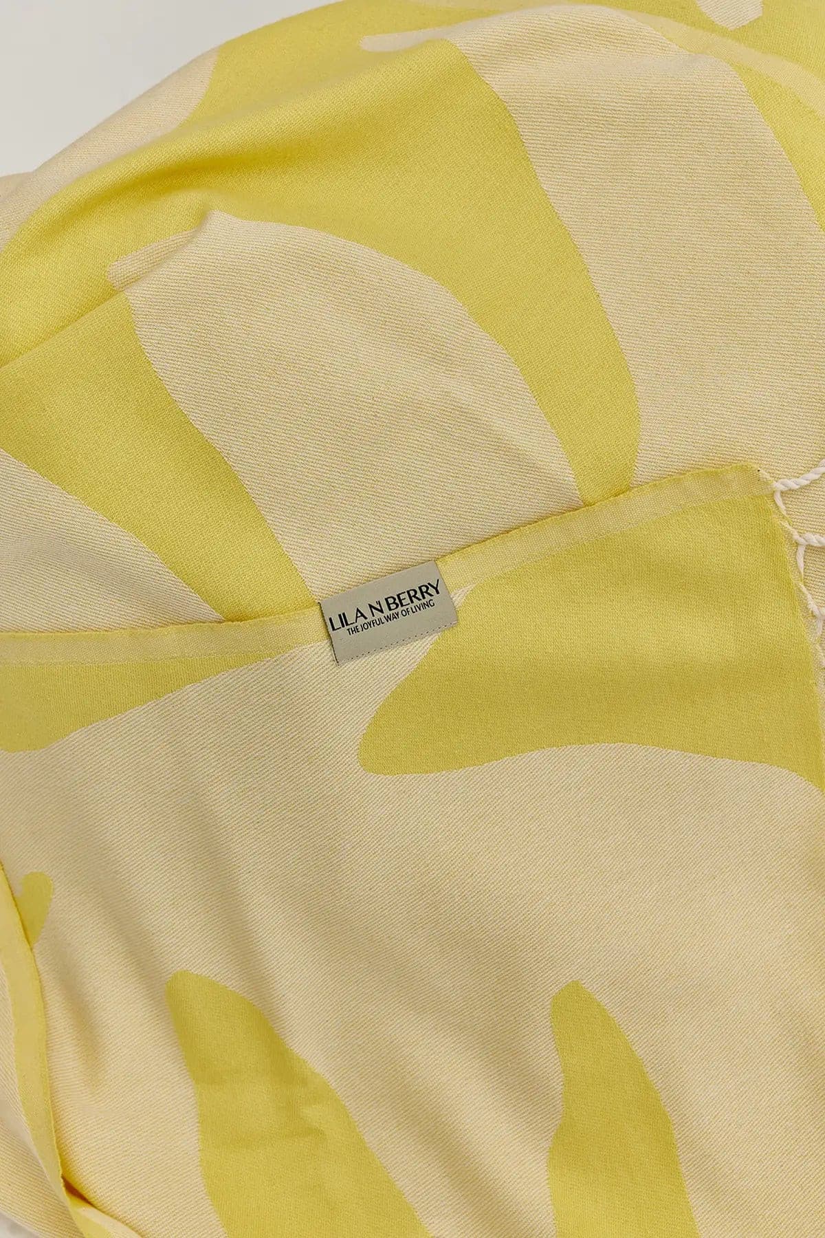 Fiori Turkish towel in Mellow Yellow – Close-up draped towel showing detail and texture