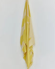 Fiori Turkish towel in Mellow Yellow – Full-length hanging view showcasing entire pattern and texture