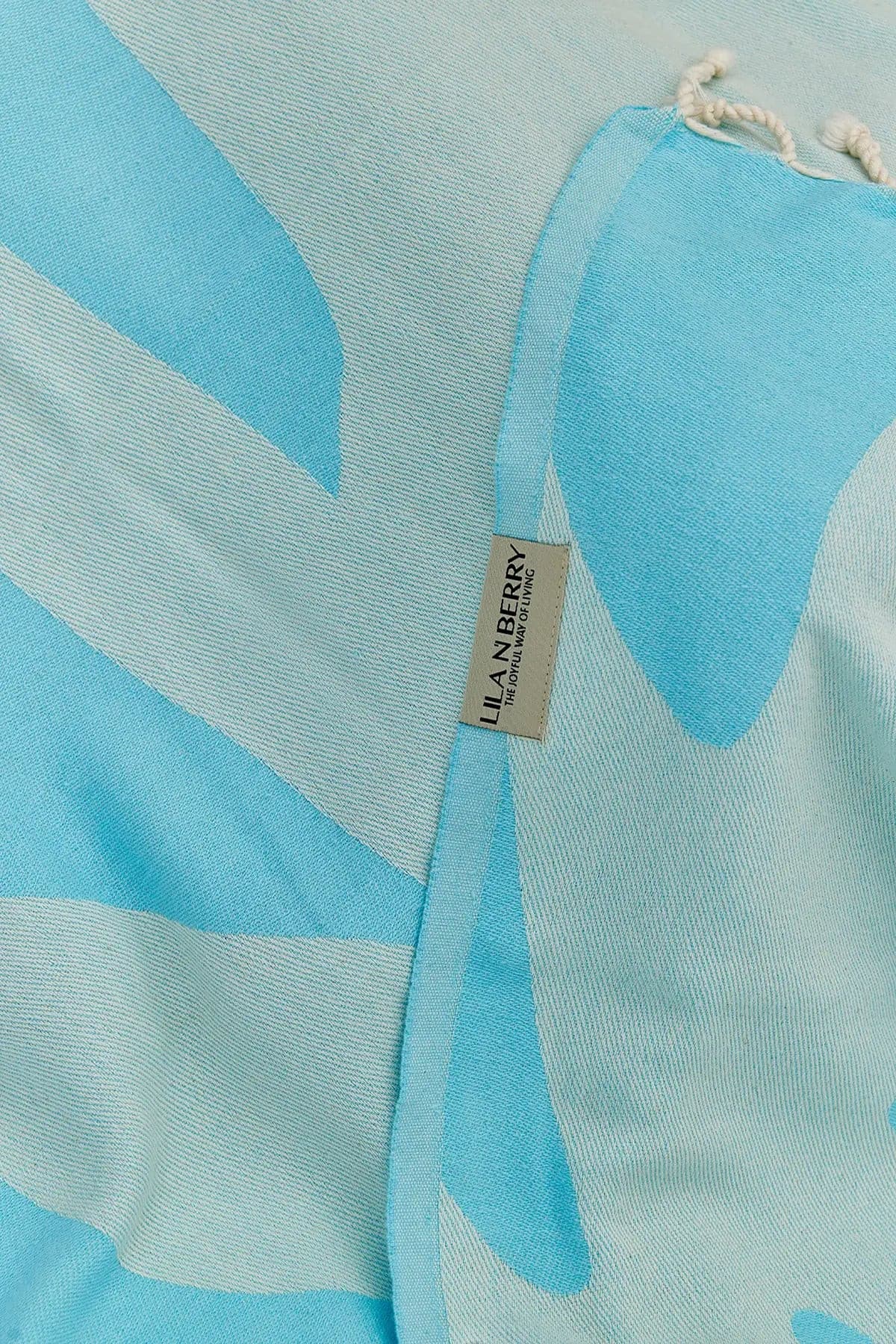Fiori Turkish towel in Sky Blue – Close-up draped towel showing detail and texture