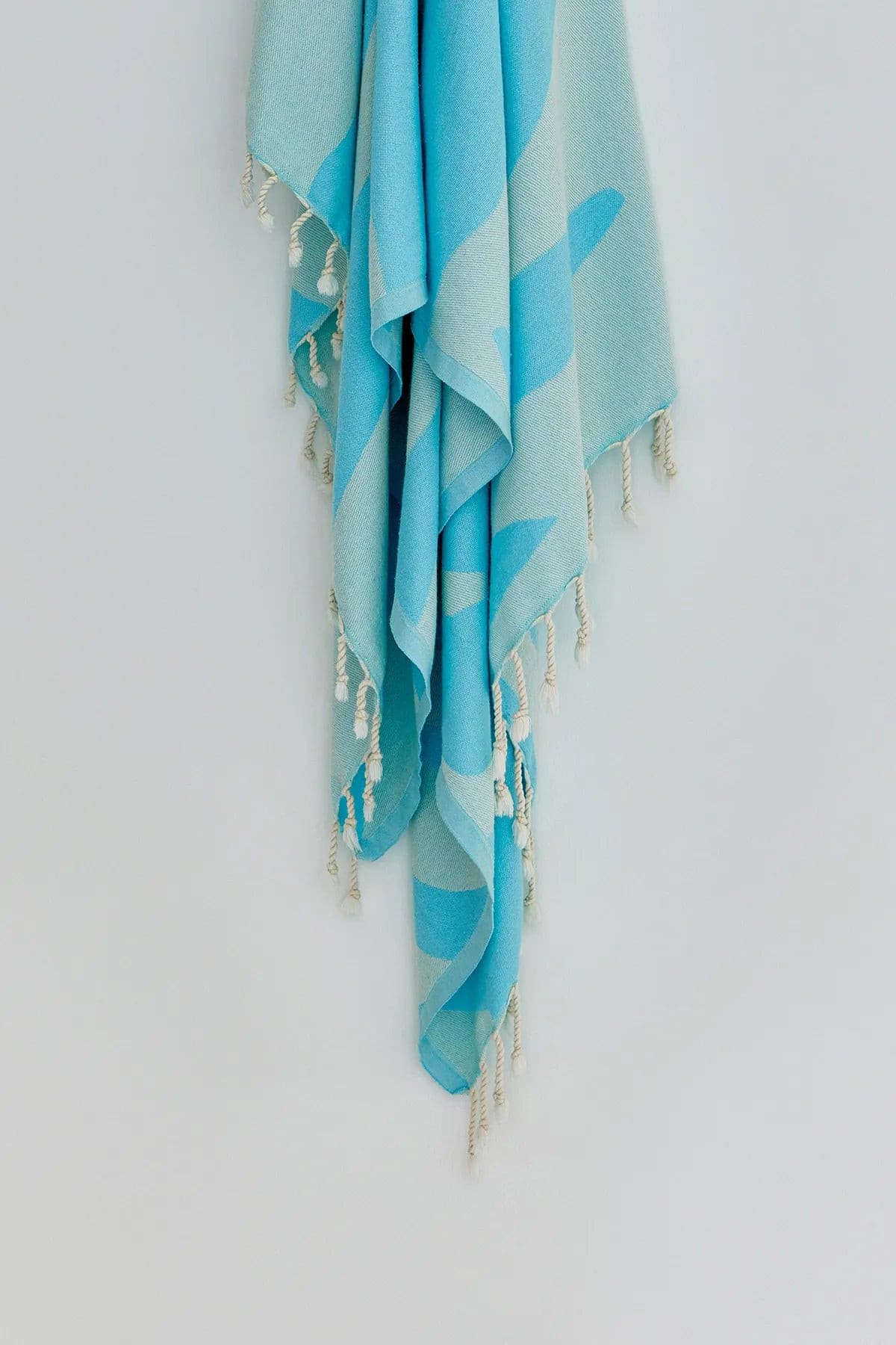 Fiori Turkish towel in Sky Blue – Close-up hanging towel highlighting weave and softness
