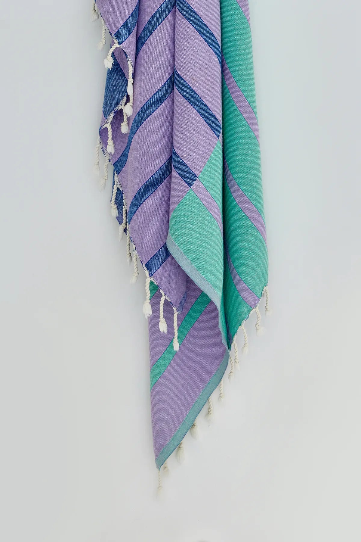 Lane Turkish towel in Lilac Green – Close-up hanging towel highlighting weave and softness