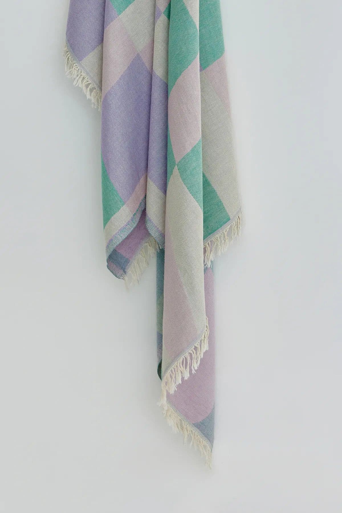 Pale Pluie Turkish towel in Mellow Green – Close-up hanging towel highlighting weave and softness